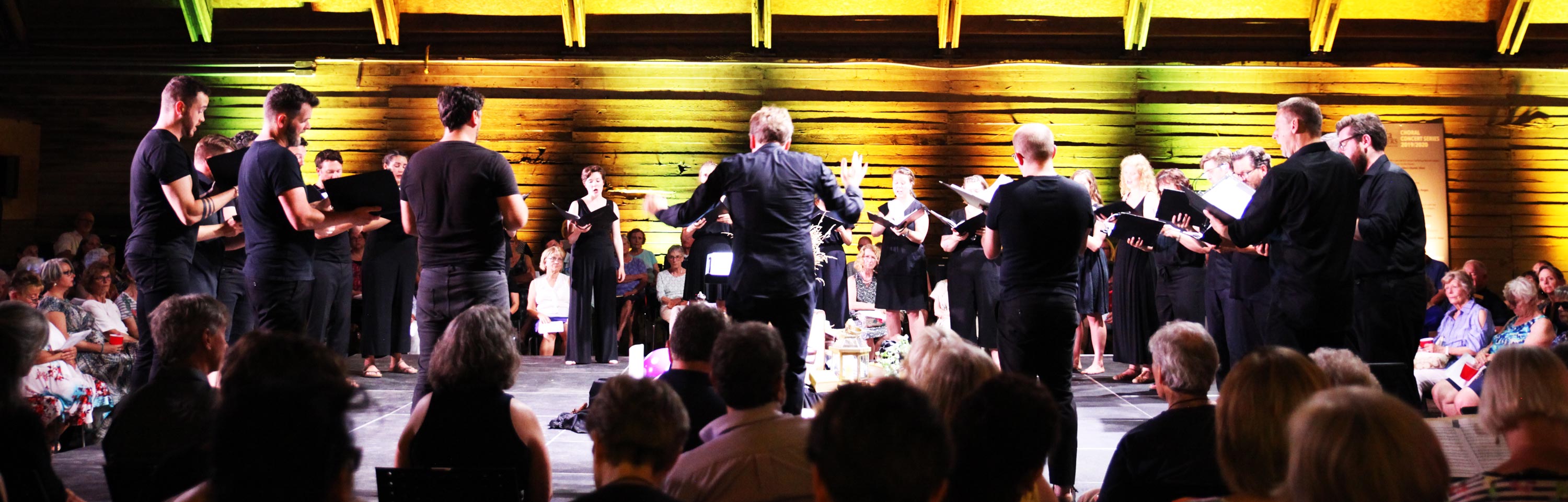 The Elora Singers performing in a barn